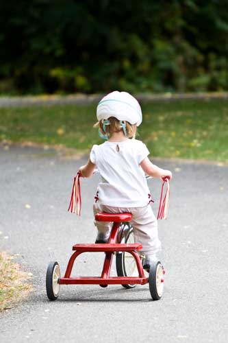 Tavistock Preschool | About us - image of child riding a red tricycle