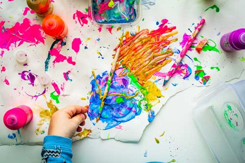 Tavistock Preschool | Home - image of bright colour paint splats and messing painting